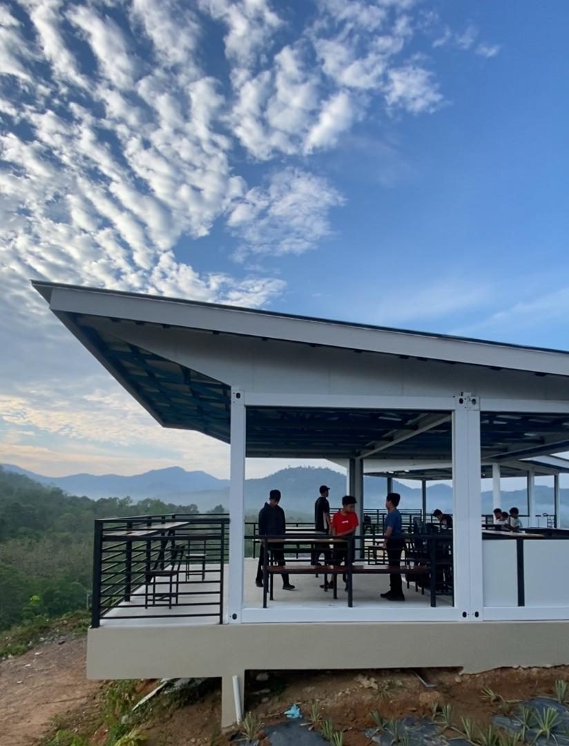 Bumbung julur putih pavilion puncak bukit dengan latar langit berawan dramatik